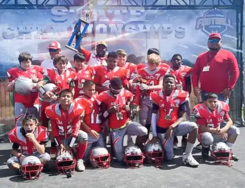 Group photo of the Labelle Longhorns 10U Football holding their regional championship trophy!