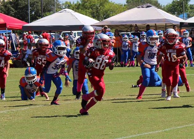 Pop Warner making a play on the football field