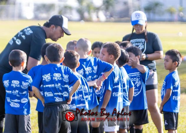 Youth Soccer League learning from the coach